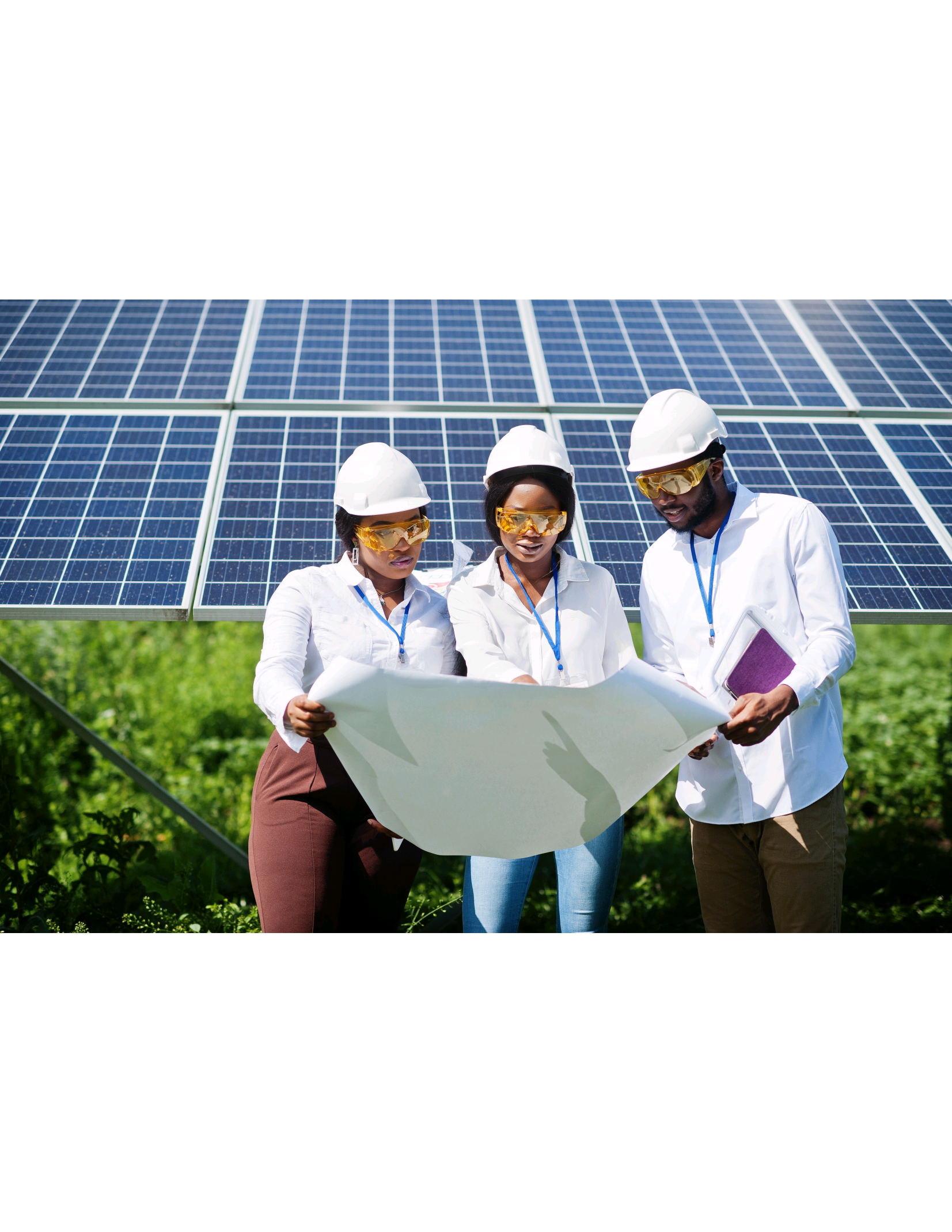 Solar energy professionals reviewing plans with solar panel installation in background